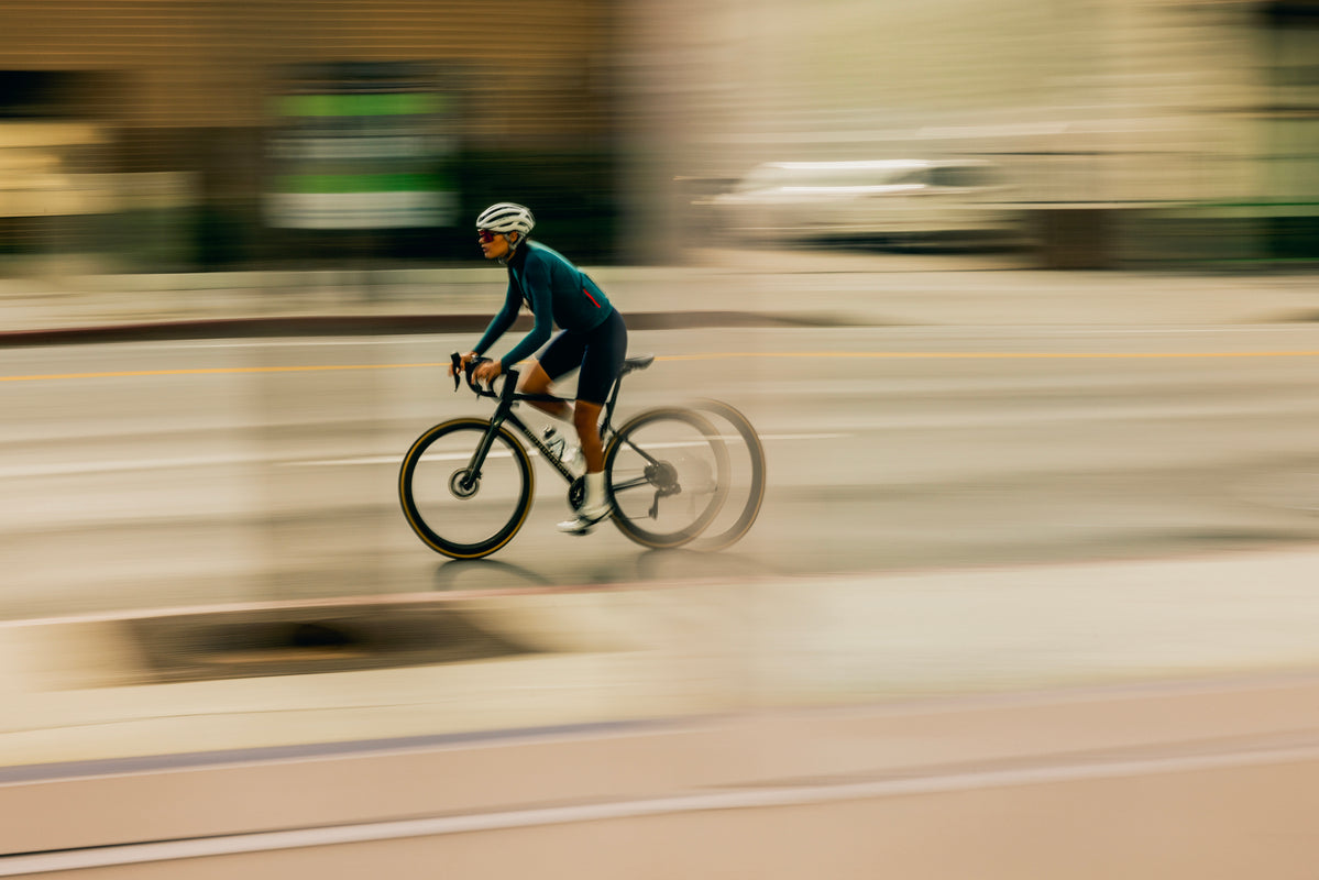 road rider climbing hill blurry image